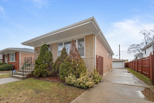 view of front of home with an outbuilding, a front yard, and a garage