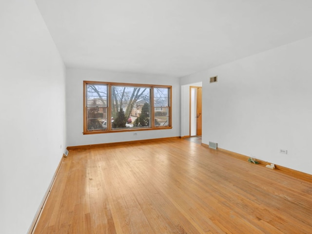 spare room with light hardwood / wood-style floors