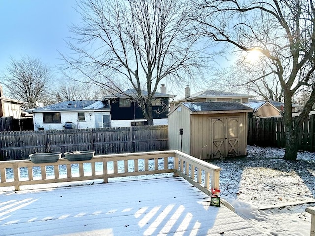 snow covered deck featuring a shed