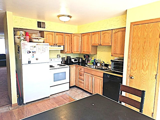 kitchen with light tile patterned flooring, white appliances, and sink