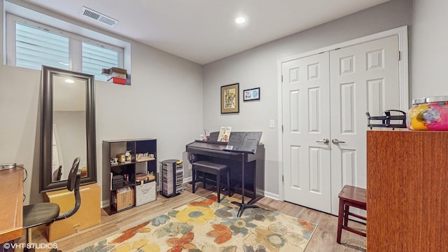 office space featuring light wood-style flooring and visible vents