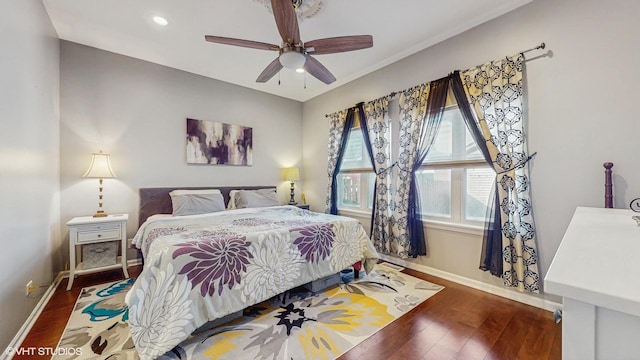 bedroom featuring dark wood-type flooring, recessed lighting, a ceiling fan, and baseboards