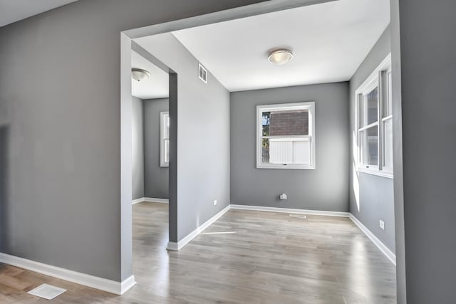 unfurnished room featuring light hardwood / wood-style flooring and a healthy amount of sunlight