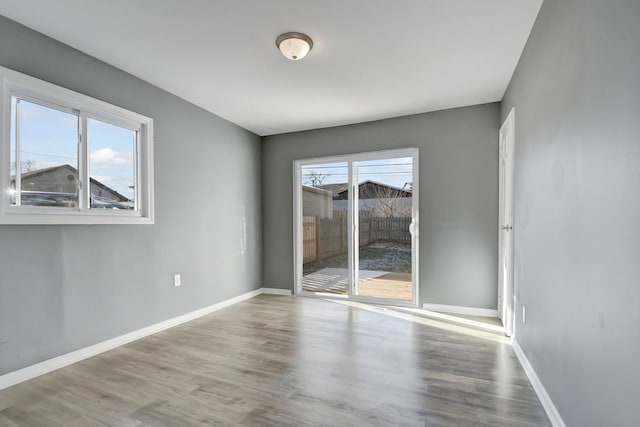 unfurnished room with hardwood / wood-style floors