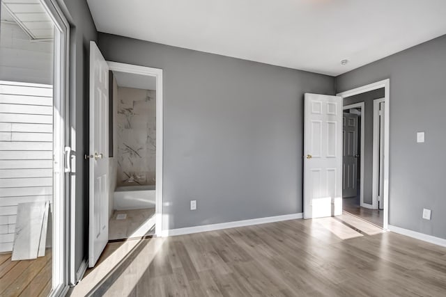 unfurnished bedroom with light wood-type flooring