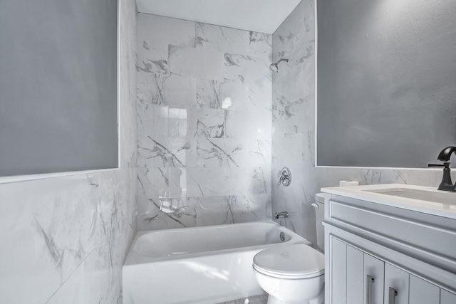 full bathroom with vanity, shower / bath combination, toilet, and tile walls