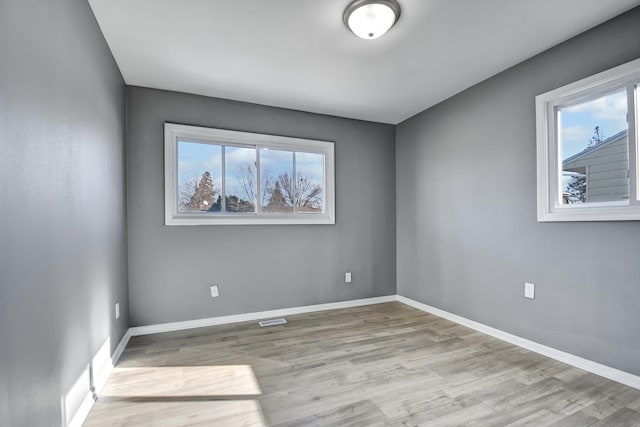 spare room with light hardwood / wood-style floors