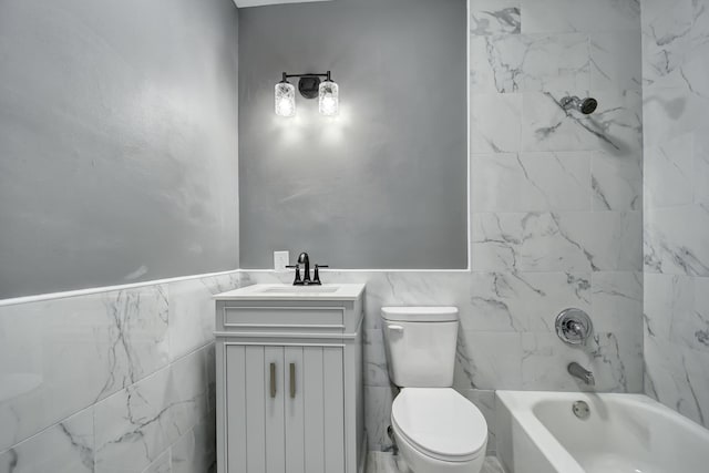 full bathroom featuring vanity, toilet, and tiled shower / bath