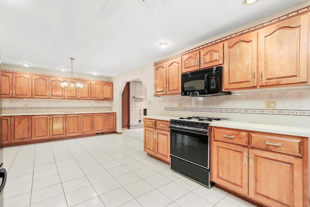 kitchen featuring light tile patterned floors, backsplash, hanging light fixtures, and black appliances