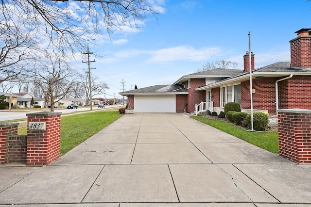 view of front of house featuring a garage and a front lawn