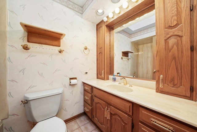 bathroom with tile patterned flooring, vanity, and toilet