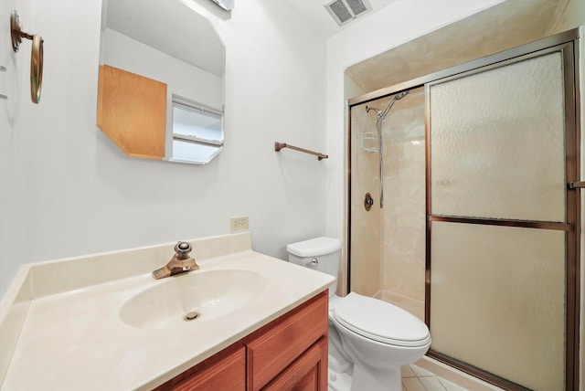 bathroom featuring vanity, toilet, and a shower with door