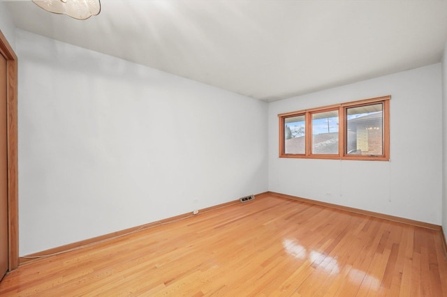 unfurnished room with hardwood / wood-style flooring