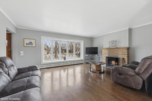 living room featuring hardwood / wood-style flooring, ornamental molding, a fireplace, and a baseboard heating unit