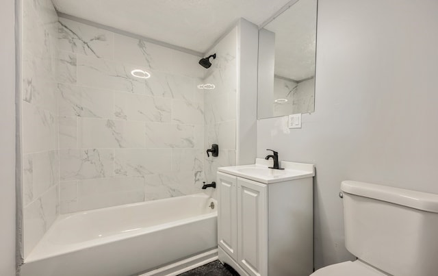 full bathroom with toilet, vanity, and tiled shower / bath