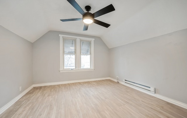 additional living space featuring ceiling fan, vaulted ceiling, baseboard heating, and light hardwood / wood-style flooring