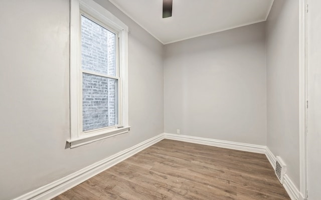 spare room with hardwood / wood-style flooring and ceiling fan