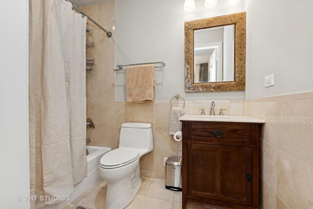 full bathroom with vanity, tile patterned floors, toilet, tile walls, and shower / tub combo with curtain