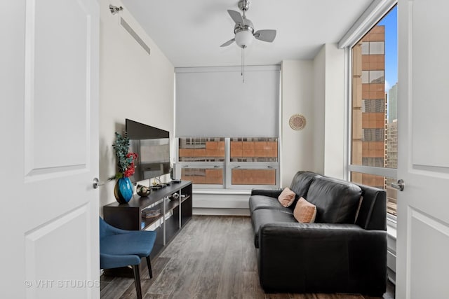 sitting room featuring ceiling fan and dark hardwood / wood-style flooring