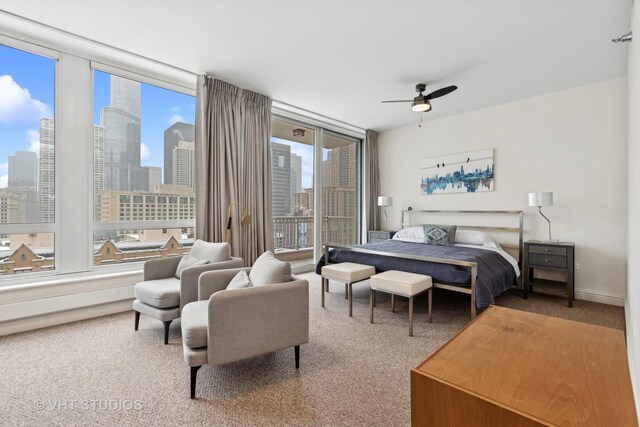 bedroom with access to outside, multiple windows, ceiling fan, and carpet