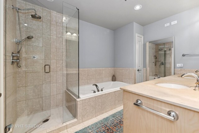 bathroom featuring tile patterned floors, separate shower and tub, and vanity