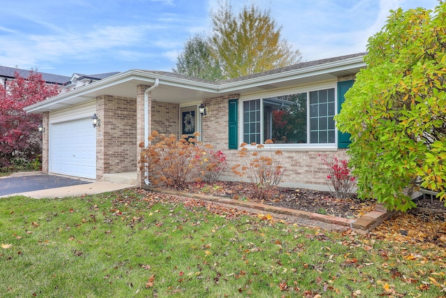 single story home featuring a garage and a front lawn