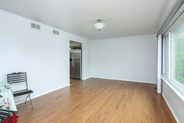 empty room with light hardwood / wood-style flooring