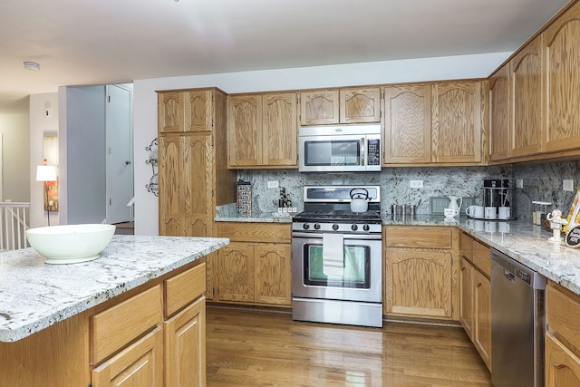 kitchen featuring decorative backsplash, dark hardwood / wood-style flooring, stainless steel appliances, and sink