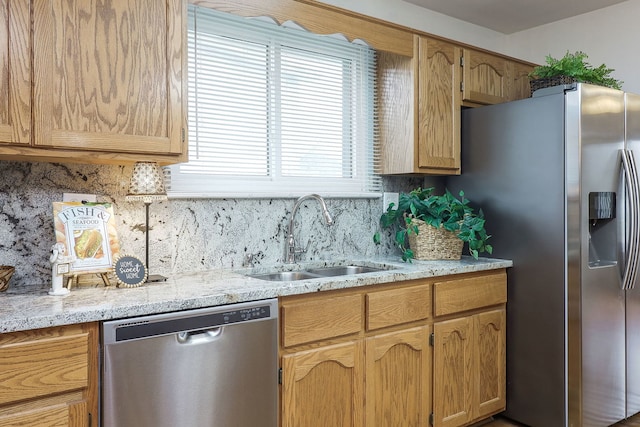 kitchen with tasteful backsplash, sink, and appliances with stainless steel finishes