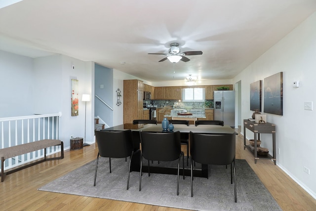 dining room with ceiling fan and light hardwood / wood-style flooring