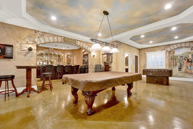 recreation room featuring pool table, a tray ceiling, bar area, and ornamental molding