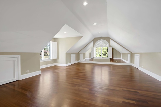 bonus room featuring a healthy amount of sunlight, baseboards, vaulted ceiling, and wood finished floors