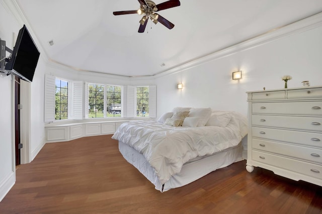 bedroom with dark wood-style floors, lofted ceiling, visible vents, and crown molding