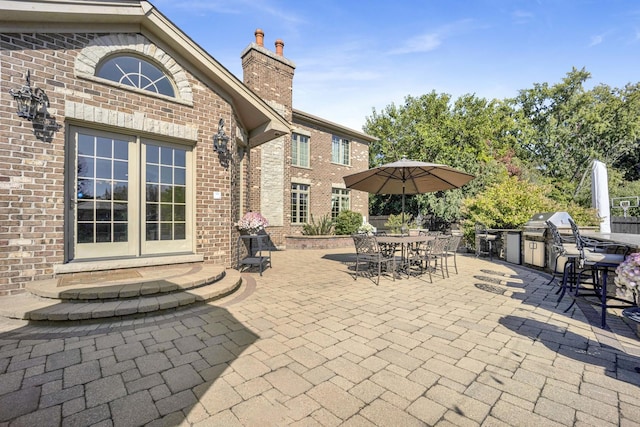 view of patio featuring exterior kitchen, grilling area, and outdoor dining space