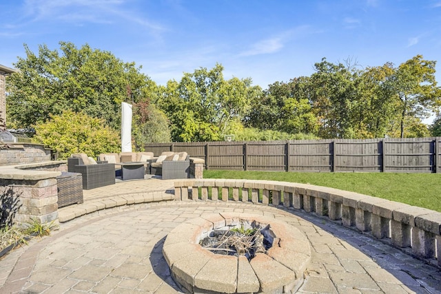 view of patio / terrace featuring a fenced backyard and an outdoor living space with a fire pit