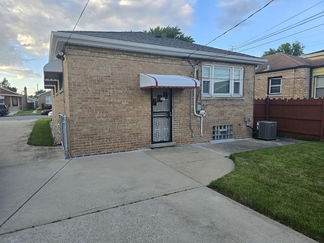 exterior space featuring a lawn and cooling unit