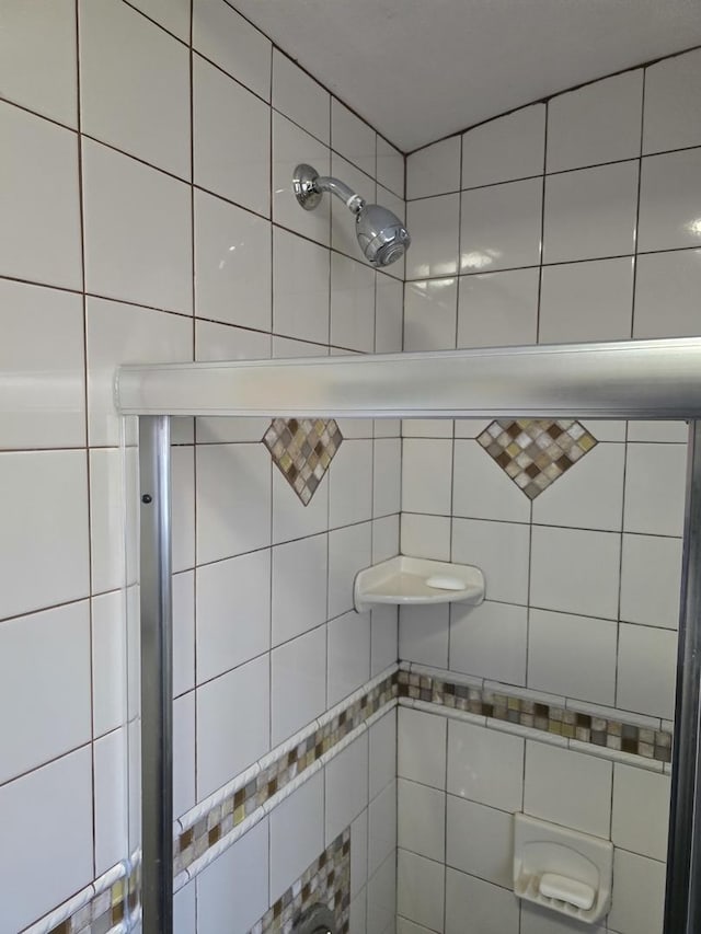 bathroom with a tile shower