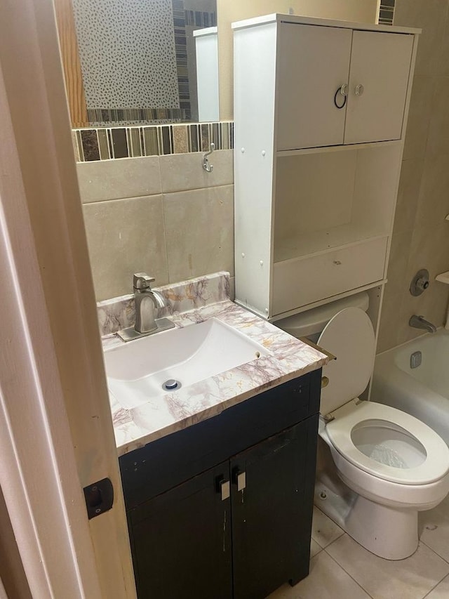 full bathroom featuring tile patterned floors, toilet, shower / washtub combination, vanity, and tile walls