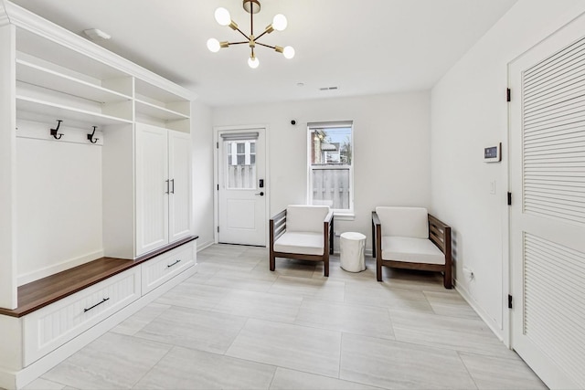 mudroom with a chandelier