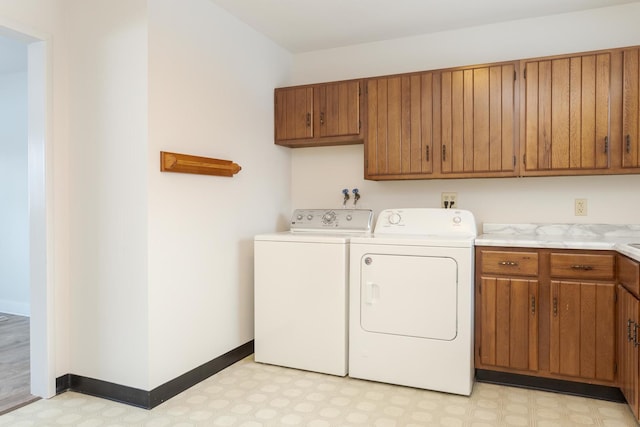 washroom with cabinets and separate washer and dryer