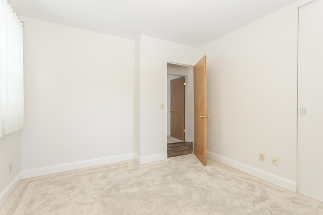 empty room featuring light colored carpet