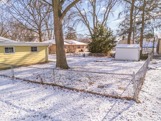 yard layered in snow featuring an outdoor structure