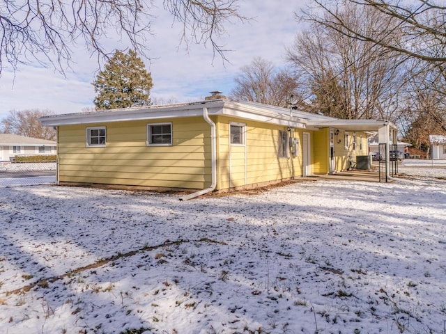 snow covered house with cooling unit