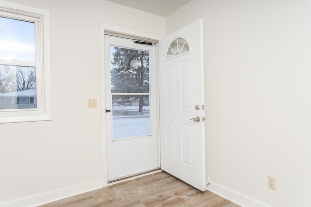 doorway to outside with light wood-type flooring