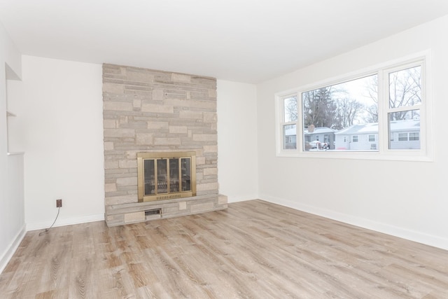 unfurnished living room with light hardwood / wood-style floors and a fireplace