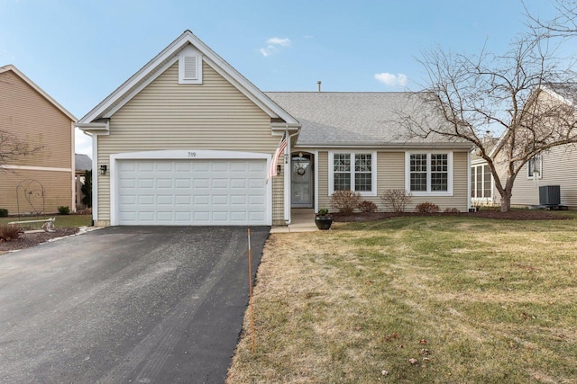 ranch-style house featuring a front lawn, cooling unit, and a garage