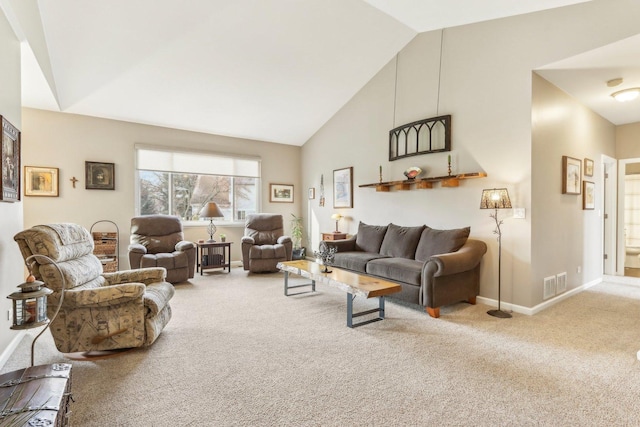 carpeted living room with high vaulted ceiling