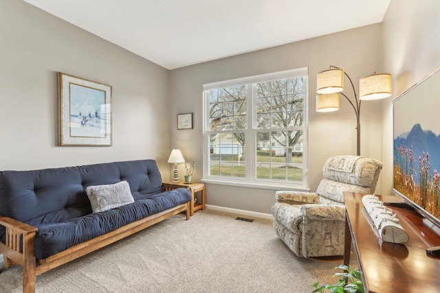 living room featuring carpet flooring and a healthy amount of sunlight