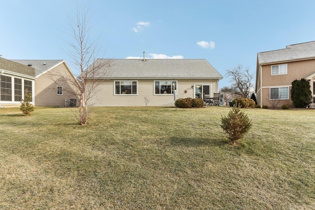 back of house featuring a yard