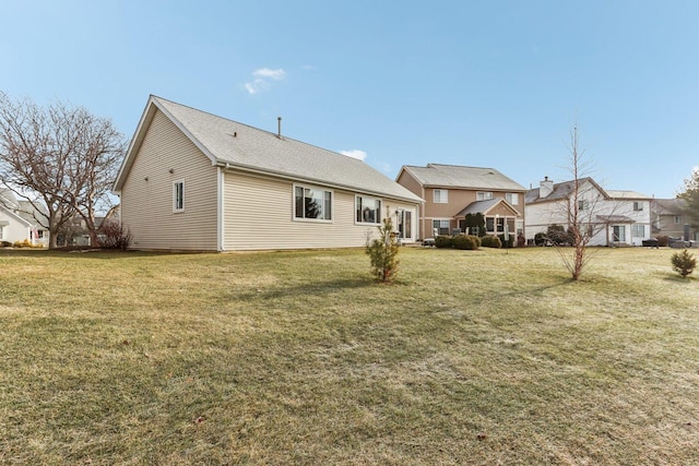 rear view of house with a yard